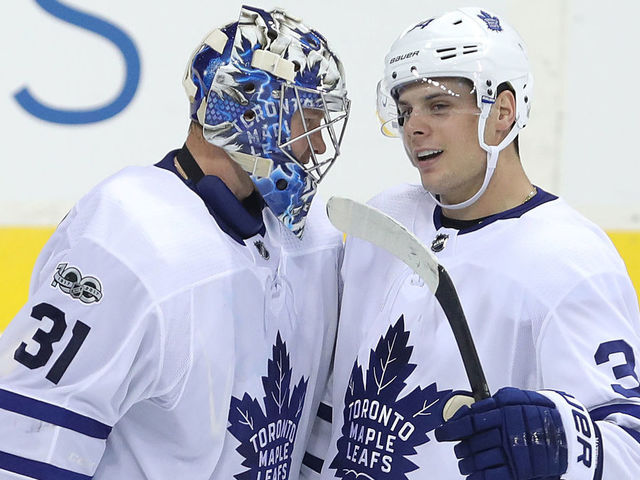 WINNIPEG, MANITOBA - OCTOBER 4: Forward Auston Matthews #34 of the Toronto Maple Leafs congratulates goaltender Frederik Andersen #31 after defeating the Winnipeg Jets during NHL action on October 4, 2017 at the Bell MTS Place in Winnipeg, Manitoba.