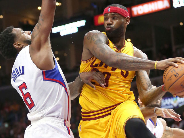 LOS ANGELES, CA - JANUARY 16: LeBron James #23 of the Cleveland Cavaliers jumps to throw a pass around DeAndre Jordan #6 of the Los Angeles Clippers at Staples Center on January 16, 2015 in Los Angeles, California. The Cavaliers won 126-121.
