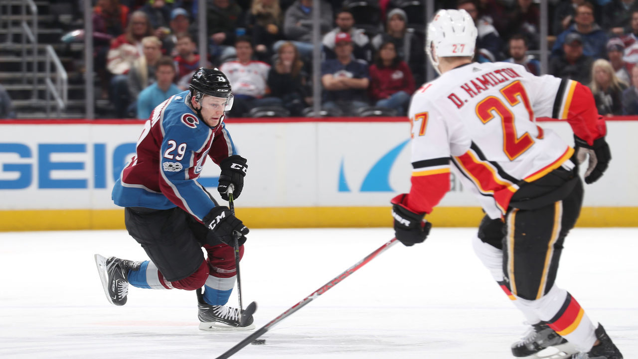 DENVER, CO - NOVEMBER 25: Nathan MacKinnon #29 of the Colorado Avalanche skates against Dougie Hamilton #27 of the Calgary Flames at the Pepsi Center on November 25, 2017 in Denver, Colorado. The Flames defeated the Avalanche 3-2.