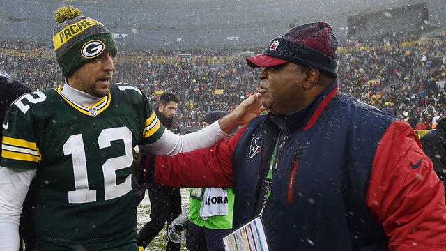 GREEN BAY, WI - DECEMBER 04: Aaron Rodgers #12 of the Green Bay Packers greets defensive coordinator Romeo Crennel of the Houston Texans following a game at Lambeau Field on December 4, 2016 in Green Bay, Wisconsin. Green Bay defeated Houston 21-13.