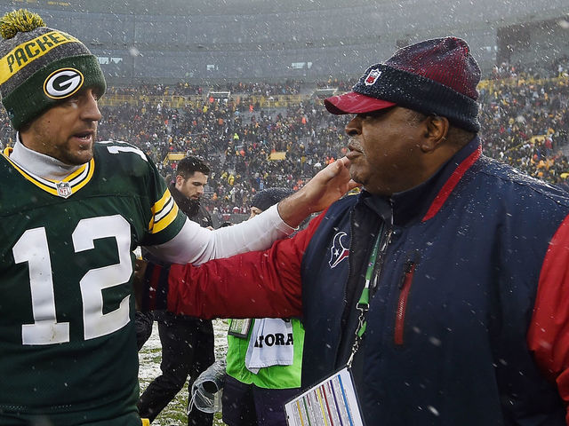 GREEN BAY, WI - DECEMBER 04: Aaron Rodgers #12 of the Green Bay Packers greets defensive coordinator Romeo Crennel of the Houston Texans following a game at Lambeau Field on December 4, 2016 in Green Bay, Wisconsin. Green Bay defeated Houston 21-13.