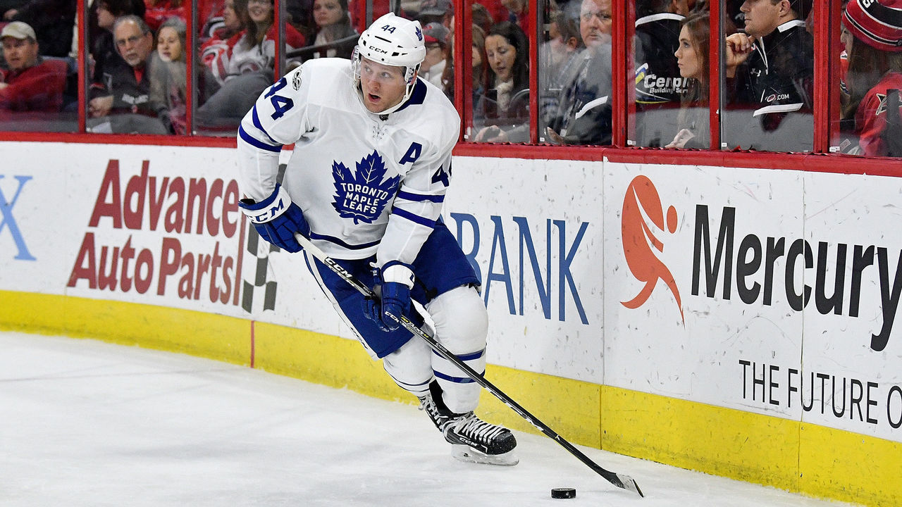 RALEIGH, NC - NOVEMBER 24: Morgan Rielly #44 of the Toronto Maple Leafs moves the puck against the Carolina Hurricanes during thir game at PNC Arena on November 24, 2017 in Raleigh, North Carolina.