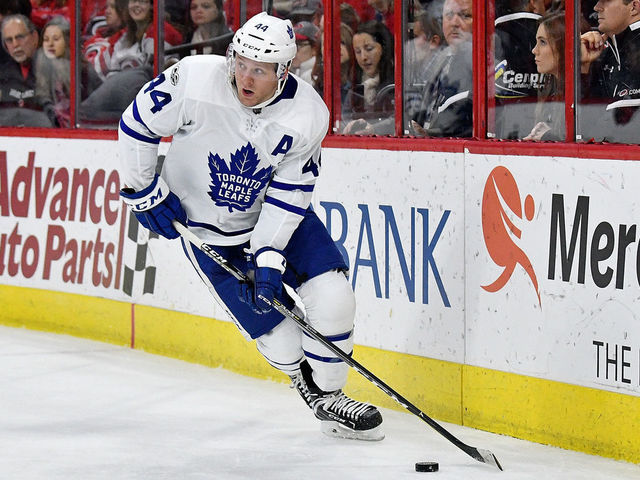 RALEIGH, NC - NOVEMBER 24: Morgan Rielly #44 of the Toronto Maple Leafs moves the puck against the Carolina Hurricanes during thir game at PNC Arena on November 24, 2017 in Raleigh, North Carolina.