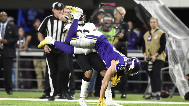 MINNEAPOLIS, MN - JANUARY 14: Adam Thielen #19 of the Minnesota Vikings is flipped upside down after catching the ball in the first half of the NFC Divisional Playoff game against the New Orleans Saints on January 14, 2018 at U.S. Bank Stadium in Minneapolis, Minnesota.