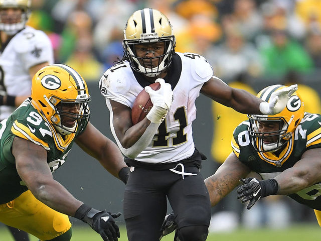 GREEN BAY, WI - OCTOBER 22: Alvin Kamara #41 of the New Orleans Saints runs between Kenny Clark #97 and Mike Daniels #76 of the Green Bay Packers during the second half at Lambeau Field on October 22, 2017 in Green Bay, Wisconsin.