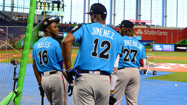 MIAMI, FL - JULY 9: Victor Robles #16, Eloy Jimenez #12, and Vladimir Guerrero Jr. #27 of the World Team look on during batting practice prior to the SirusXM All-Star Futures Game at Marlins Park on Sunday, July 9, 2017 in Miami, Florida.