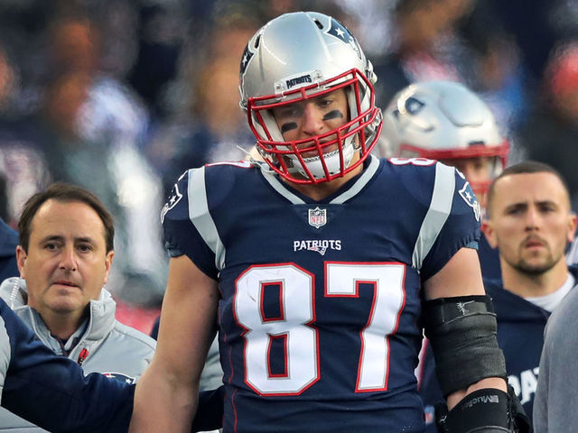 FOXBOROUGH, MA - JANUARY 21: New England Patriots tight end Rob Gronkowski is escorted to the locker room after being hit in the head on a play late in the second quarter. The New England Patriots host the Jacksonville Jaguars in an NFL AFC championship game at Gillette Stadium in Foxborough, MA on Jan. 21, 2018.