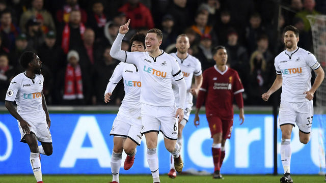 SWANSEA, WALES - JANUARY 22: Alfie Mawson of Swansea City celebrates scoring his side's first goal during the Premier League match between Swansea City and Liverpool at Liberty Stadium on January 22, 2018 in Swansea, Wales.