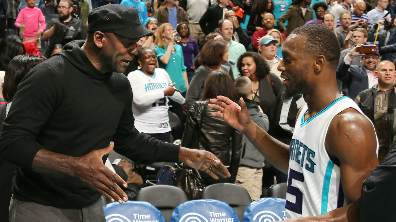 CHARLOTTE, NC - NOVEMBER 25: Hornets owner Michael Jordan high fives Kemba Walker #15 after the game against the Washington Wizards during the game on November 25, 2015 at Time Warner Cable Arena in Charlotte, North Carolina. Mandatory Copyright Notice: Copyright 2015 NBAE