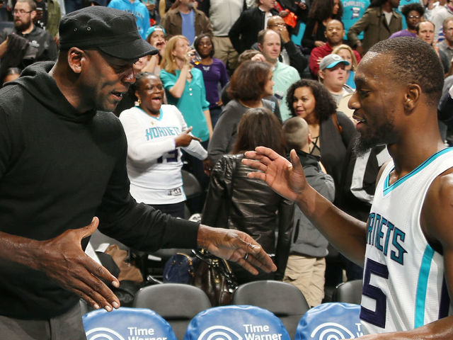 CHARLOTTE, NC - NOVEMBER 25: Hornets owner Michael Jordan high fives Kemba Walker #15 after the game against the Washington Wizards during the game on November 25, 2015 at Time Warner Cable Arena in Charlotte, North Carolina. Mandatory Copyright Notice: Copyright 2015 NBAE