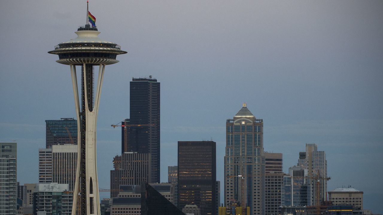 A rainbow flag flies at half mast on the Space Needle in Seattle, Washington on June 12, 2016, in honor of the victims of the nightclub shooting in Orlando. Fifty people died when a gunman allegedly inspired by the Islamic State group opened fire inside a gay nightclub in Florida, in the worst terror attack on US soil since September 11, 2001. / AFP / OMAR TORRES