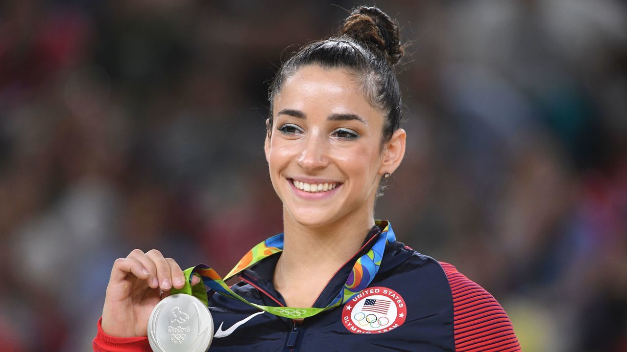 US gymnast Alexandra Raisman celebrates on the podium of the women's floor event final of the Artistic Gymnastics at the Olympic Arena during the Rio 2016 Olympic Games in Rio de Janeiro on August 16, 2016. / AFP / Toshifumi KITAMURA