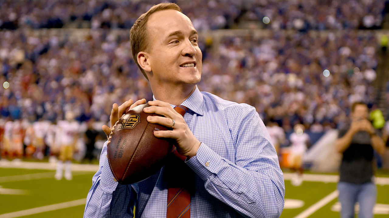 INDIANAPOLIS, IN - OCTOBER 08: Peyton Manning steps back to throw a pass to former teammate Marvin Harrison during a presentation to retire Manning's number during the halftime of the game between the Indianapolis Colts and the San Francisco 49ers at Lucas Oil Stadium on October 8, 2017 in Indianapolis, Indiana.