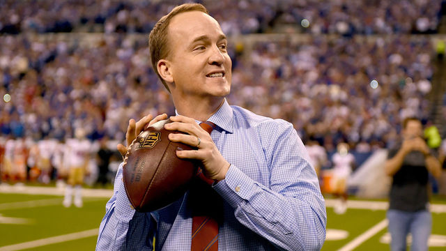 INDIANAPOLIS, IN - OCTOBER 08: Peyton Manning steps back to throw a pass to former teammate Marvin Harrison during a presentation to retire Manning's number during the halftime of the game between the Indianapolis Colts and the San Francisco 49ers at Lucas Oil Stadium on October 8, 2017 in Indianapolis, Indiana.