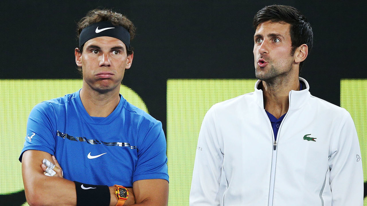 MELBOURNE, AUSTRALIA - JANUARY 10: Rafael Nadal of Spain (L) and Novak Djokovic of Serbia hits a forehand react after watching a video replay while on the sidelines during the Tie Break Tens ahead of the 2018 Australian Open at Margaret Court Arena on January 10, 2018 in Melbourne, Australia.