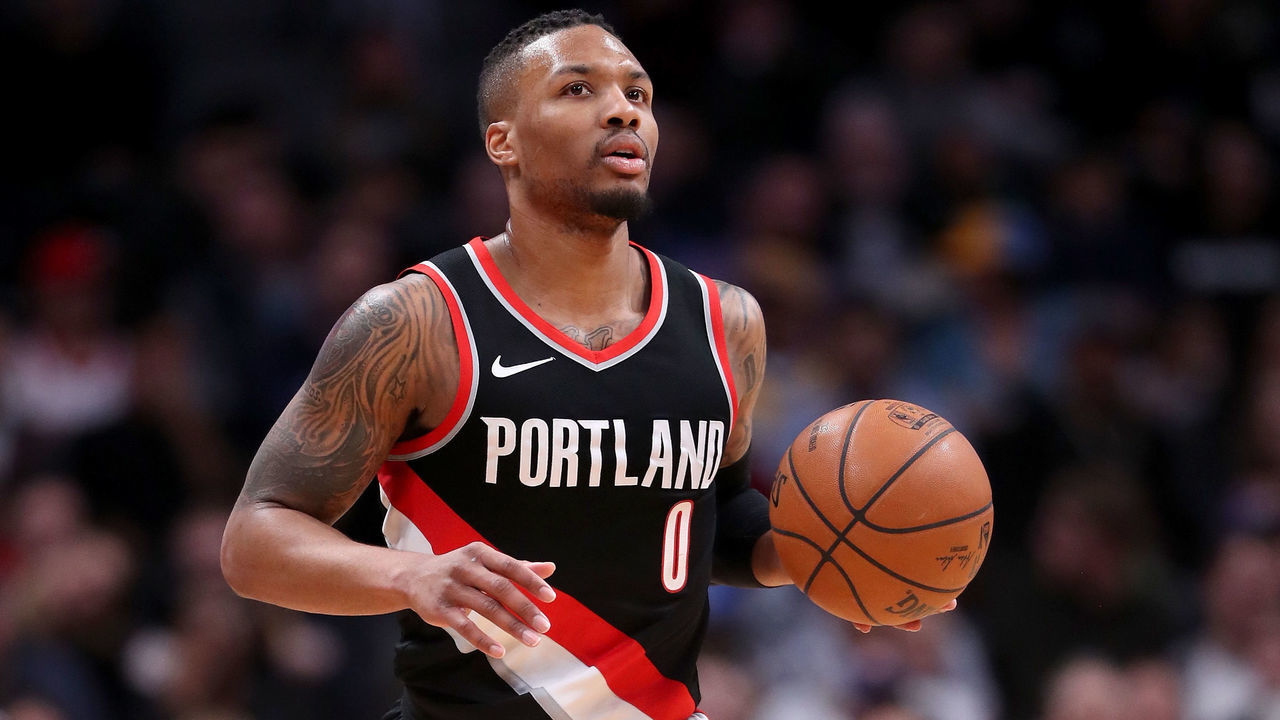 DENVER, CO - JANUARY 22: Damian Lillard #0 of the Portland Trail Blazers brings the ball down the court against the Denver Nuggets at the Pepsi Center on January 22, 2018 in Denver, Colorado.