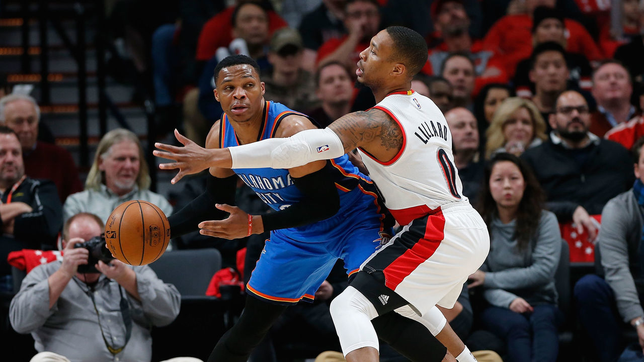 PORTLAND, OR - DECEMBER 13: Russell Westbrook #0 of the Oklahoma City Thunder is guarded by Damian Lillard #0 of the Portland Trail Blazers at Moda Center on December 13, 2016 in Portland, Oregon.