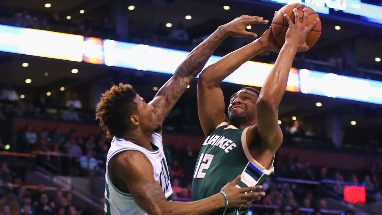 BOSTON, MA - FEBRUARY 25: Jabari Parker #12 of the Milwaukee Bucks draws a foul from Marcus Smart #36 of the Boston Celtics during the first quarter at TD Garden on February 25, 2016 in Boston, Massachusetts.