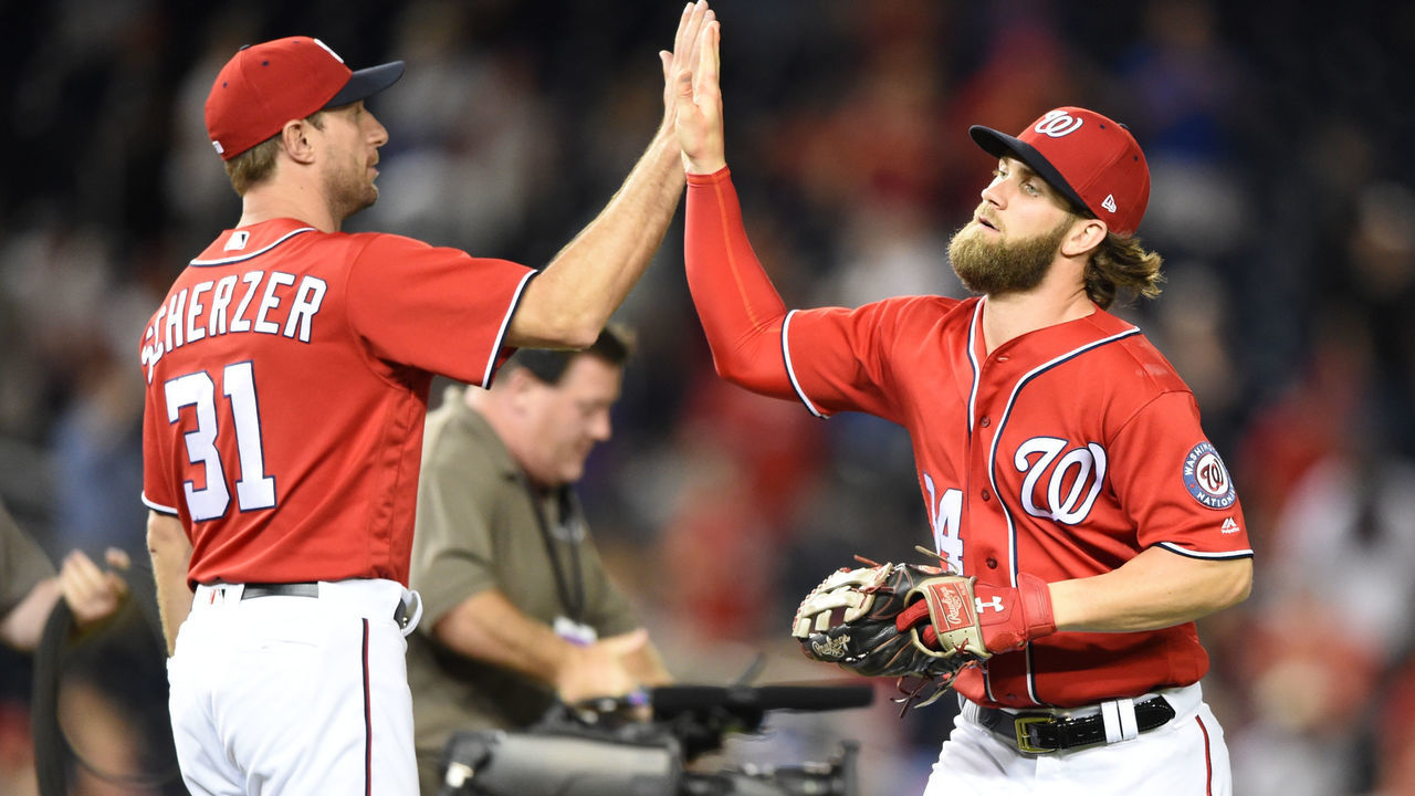 WASHINGTON, DC - JULY 30: Bryce Harper #34 of the Washington Nationals celebrates a win with Max Scherzer #31 after game two of a doubleheader against the Colorado Rockies at Nationals Park on July 30, 2017 in Washington, DC.