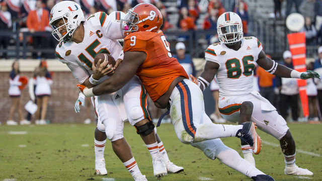 CHARLOTTESVILLE, VA - NOVEMBER 12: Brad Kaaya #15 of the Miami Hurricanes is sacked by Andrew Brown #9 of the Virginia Cavaliers during a game at Scott Stadium on November 12, 2016 in Charlottesville, Virginia.