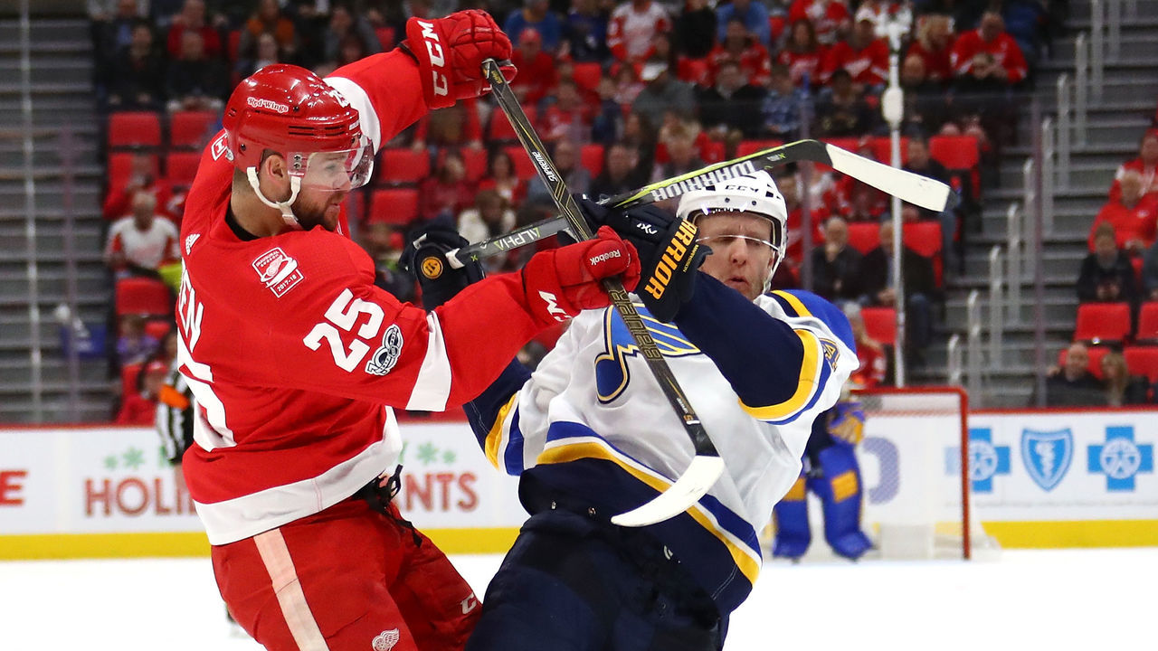 DETROIT, MI - DECEMBER 09: Mike Green #25 of the Detroit Red Wings lays a first period hit on Carl Gunnarsson #4 of the St. Louis Blues at Little Caesars Arena on December 9, 2017 in Detroit, Michigan.