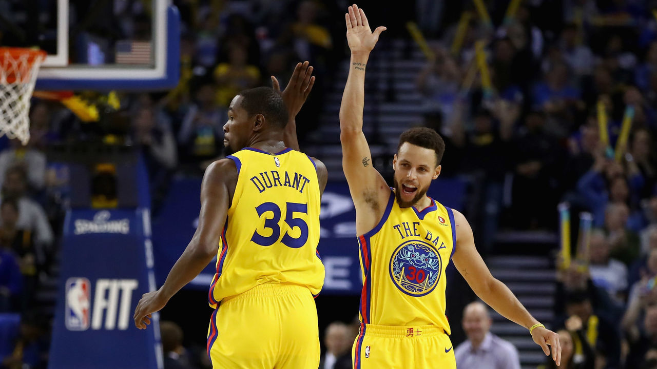 OAKLAND, CA - JANUARY 25: Stephen Curry #30 of the Golden State Warriors congratulates Kevin Durant #35 after he made a basket against the Minnesota Timberwolves at ORACLE Arena on January 25, 2018 in Oakland, California.