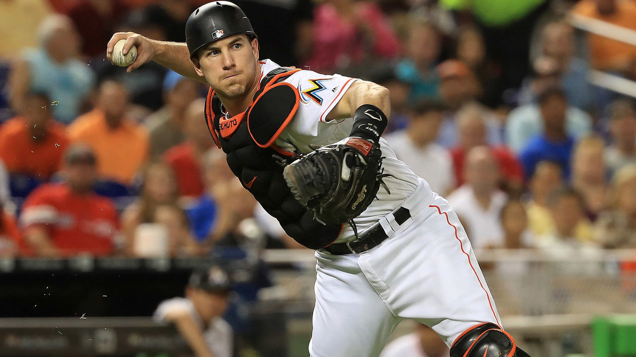 MIAMI, FL - JUNE 20: J.T. Realmuto #11 of the Miami Marlins makes a throw to first during a game against the Washington Nationals at Marlins Park on June 20, 2017 in Miami, Florida.