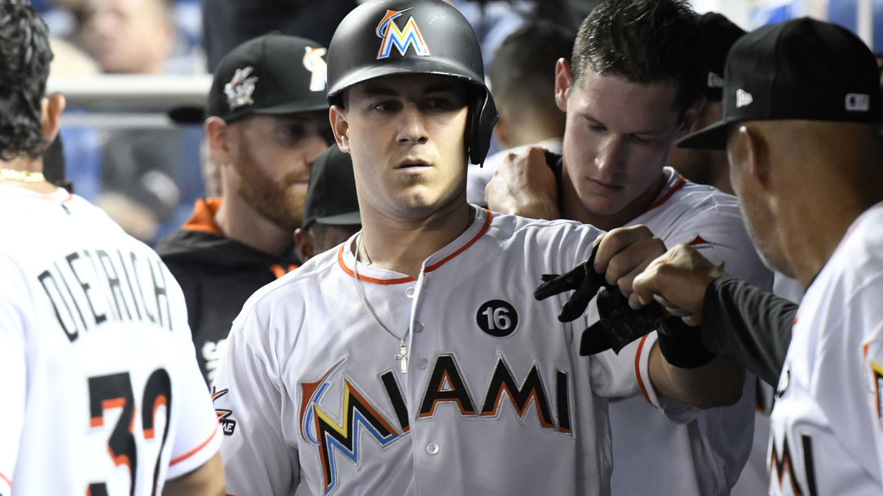 MIAMI, FL - MAY 12: J.T. Realmuto #11 of the Miami Marlins is congratulated by teammates after hitting a home run in the seventh inning against the Atlanta Braves at Marlins Park on May 12, 2017 in Miami, Florida.