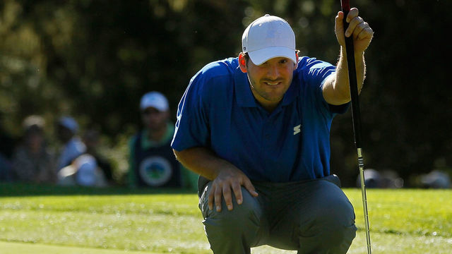PEBBLE BEACH, CA - FEBRUARY 09: (L-R) Tiger Woods looks on as football player, amateur Tony Romo, lines up his putt on the 11th green during the first round of the AT&T Pebble Beach National Pro-Am at the Spyglass Hill Golf Course on February 9, 2012 in Pebble Beach, California.