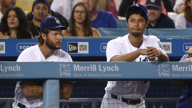 LOS ANGELES, CA - AUGUST 11: (L-R) Alex Wood #57, Clayton Kershaw #22 and Yu Darvish #21 of the Los Angeles Dodgers look on from the dugout with the Dodgers down 4-3 to the San Diego Padres during the ninth inning of their MLB game at Dodger Stadium on August 11, 2017 in Los Angeles, California. The Padres defeated the Dodgers 4-3.