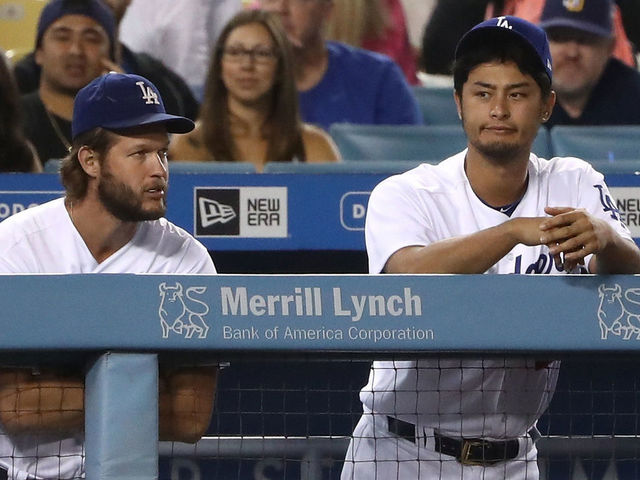 LOS ANGELES, CA - AUGUST 11: (L-R) Alex Wood #57, Clayton Kershaw #22 and Yu Darvish #21 of the Los Angeles Dodgers look on from the dugout with the Dodgers down 4-3 to the San Diego Padres during the ninth inning of their MLB game at Dodger Stadium on August 11, 2017 in Los Angeles, California. The Padres defeated the Dodgers 4-3.