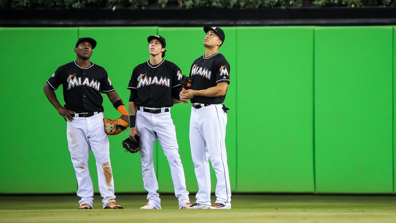 MIAMI, FL - SEPTEMBER 27: Marcell Ozuna #13, Christian Yelich #21 and Giancarlo Stanton #27 of the Miami Marlins look on during the game against the New York Mets at Marlins Park on September 27, 2016 in Miami, Florida.