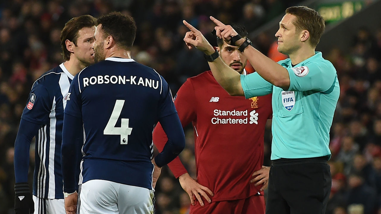 Referee Craig Pawson indicates that he's going to the VAR (Video Assistant Referee), before disallowing their third goal, during the English FA Cup fourth round football match between Liverpool and West Bromwich Albion at Anfield in Liverpool, north west England on January 27, 2018. / AFP PHOTO / PAUL ELLIS /