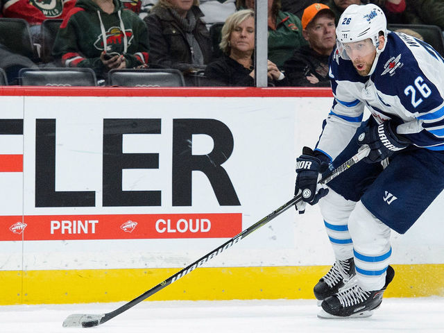ST PAUL, MN - OCTOBER 31: Blake Wheeler #26 of the Winnipeg Jets controls the puck against the Minnesota Wild during the game on October 31, 2017 at Xcel Energy Center in St Paul, Minnesota. The Jets defeated the Wild 2-1.