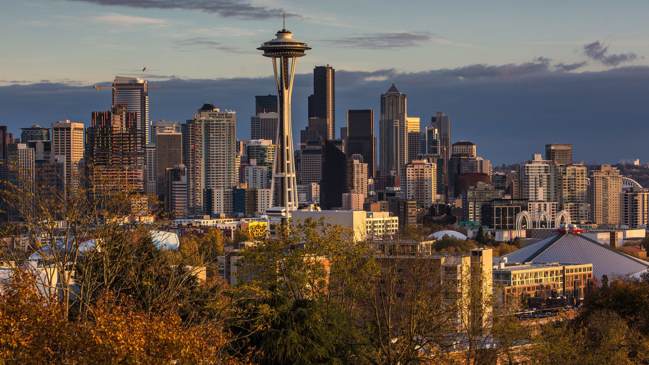 SEATTLE, WA - NOVEMBER 4: The sun sets on the Space Needle and downtown skyline as viewed from Queen Anne Hill on November 4, 2015, in Seattle, Washington. Seattle, located in King County, is the largest city in the Pacific Northwest, and is experiencing an economic boom as a result of its European and Asian global business connections.