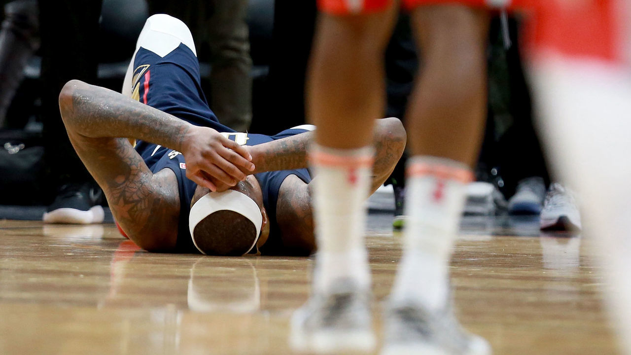 NEW ORLEANS, LA - JANUARY 26: DeMarcus Cousins #0 of the New Orleans Pelicans lies down on the ground after injuring his ankle during the second half of a NBA game against the Houston Rockets at the Smoothie King Center on January 26, 2018 in New Orleans, Louisiana.