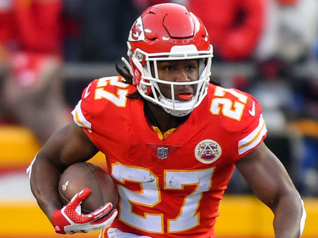 KANSAS CITY, MO - JANUARY 6:Running back Kareem Hunt #27 of the Kansas City Chiefs runs through a huge hole during the first quarter of the AFC Wild Card playoff game against the Tennessee Titans at Arrowhead Stadium on January 6, 2018 in Kansas City, Missouri.