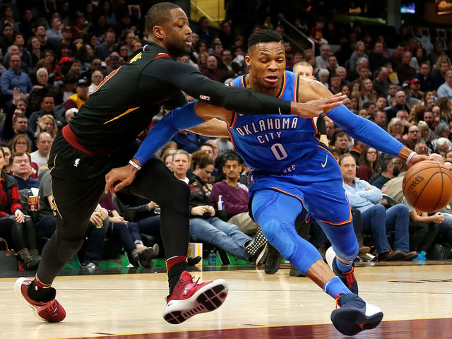 CLEVELAND, OH - JANUARY 20: Russell Westbrook #0 of the Oklahoma City Thunder attempts to drive the ball past Dwyane Wade #9 of the Cleveland Cavaliers during the first quarter at Quicken Loans Arena on January 20, 2018 in Cleveland, Ohio.