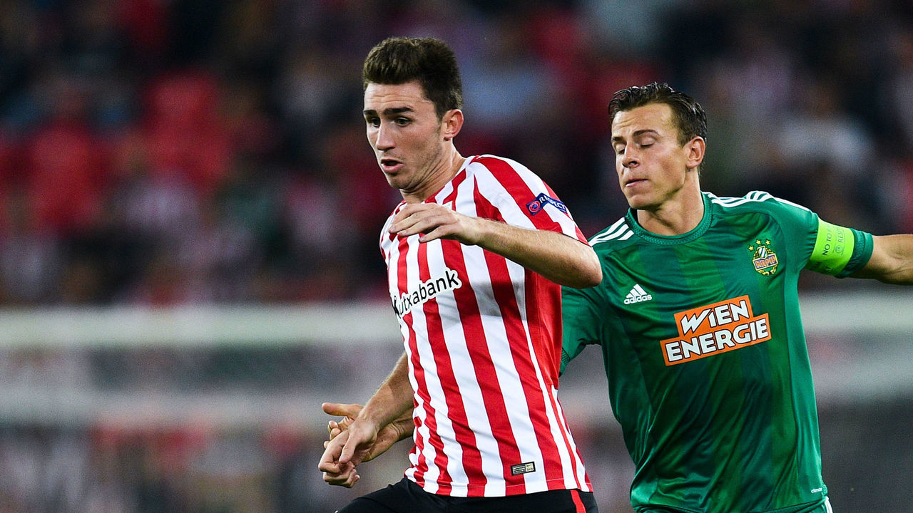 BILBAO, SPAIN - SEPTEMBER 29: Aymeric Laporte of Athletic Club competes for the ball with Stefan Schwab of SK Rapid Wien during the UEFA Europa League Group F match between Athletic Club and SK Rapid Wien at San Mames stadium on September 29, 2016 in Bilbao, Spain.
