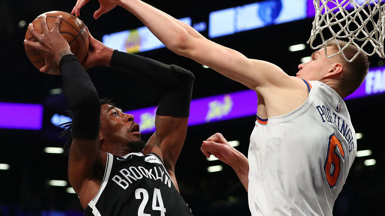NEW YORK, NY - JANUARY 15: Rondae Hollis-Jefferson #24 of the Brooklyn Nets shoots against Kristaps Porzingis #6 of the New York Knicks during their game at the Barclays Center on January 15, 2018 in New York City. . User expressly acknowledges and agrees that, by downloading and/or using this Photograph, user is consenting to the terms and conditions of the Getty Images License Agreement.