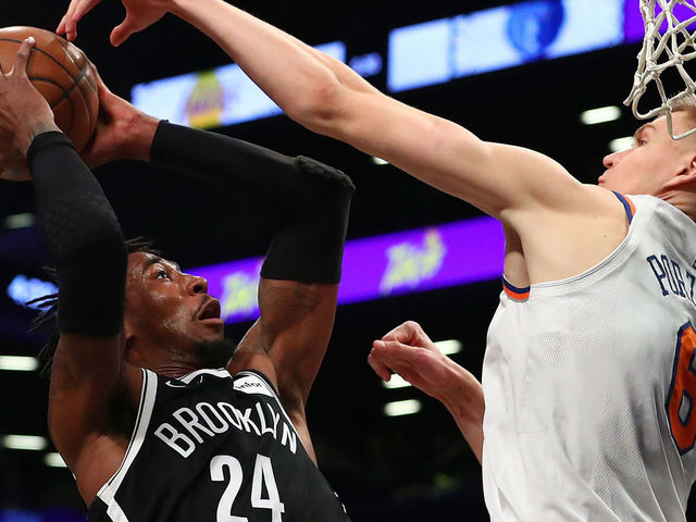 NEW YORK, NY - JANUARY 15: Rondae Hollis-Jefferson #24 of the Brooklyn Nets shoots against Kristaps Porzingis #6 of the New York Knicks during their game at the Barclays Center on January 15, 2018 in New York City. . User expressly acknowledges and agrees that, by downloading and/or using this Photograph, user is consenting to the terms and conditions of the Getty Images License Agreement.