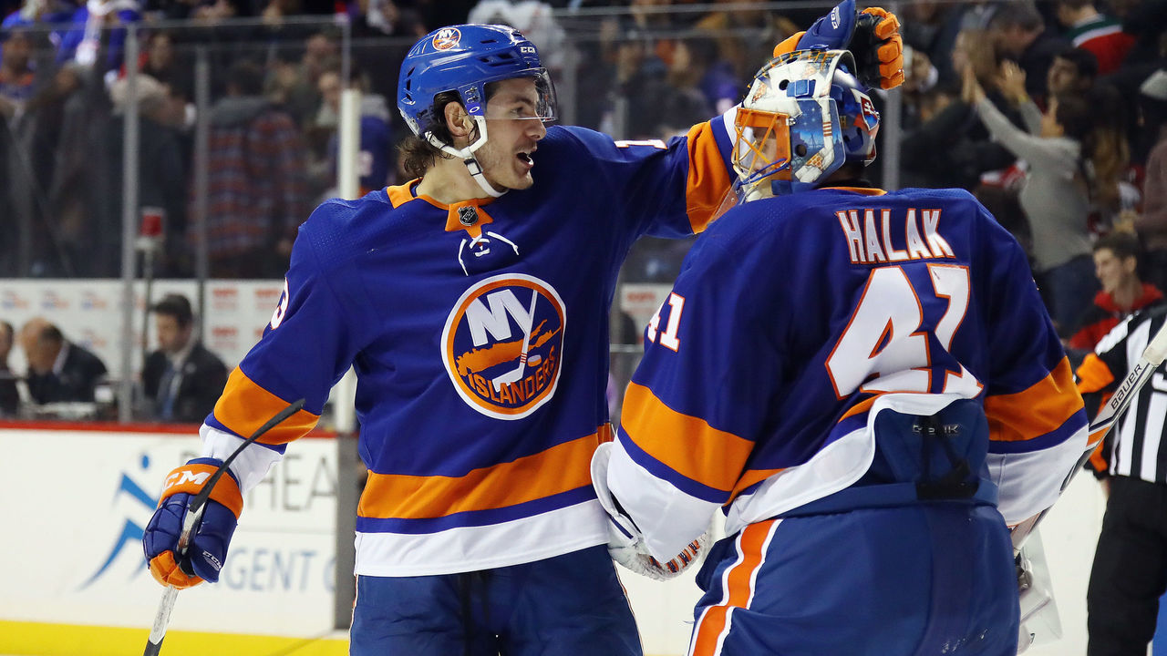 NEW YORK, NY - JANUARY 07: Mathew Barzal #13 and Jaroslav Halak #41 of the New York Islanders celebrate a victory over the New Jersey Devils at the Barclays Center on January 7, 2018 in the Brooklyn borough of New York City. The Islanders defeated the Devils 5-4 in the shootout.