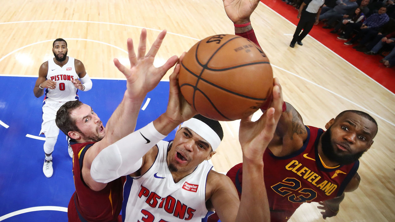 DETROIT, MI - NOVEMBER 20: Tobias Harris #34 of the Detroit Pistons splits the defense of LeBron James #23 and Kevin Love #0 of the Cleveland Cavaliers during the second half at Little Caesars Arena on November 20, 2017 in Detroit, Michigan.