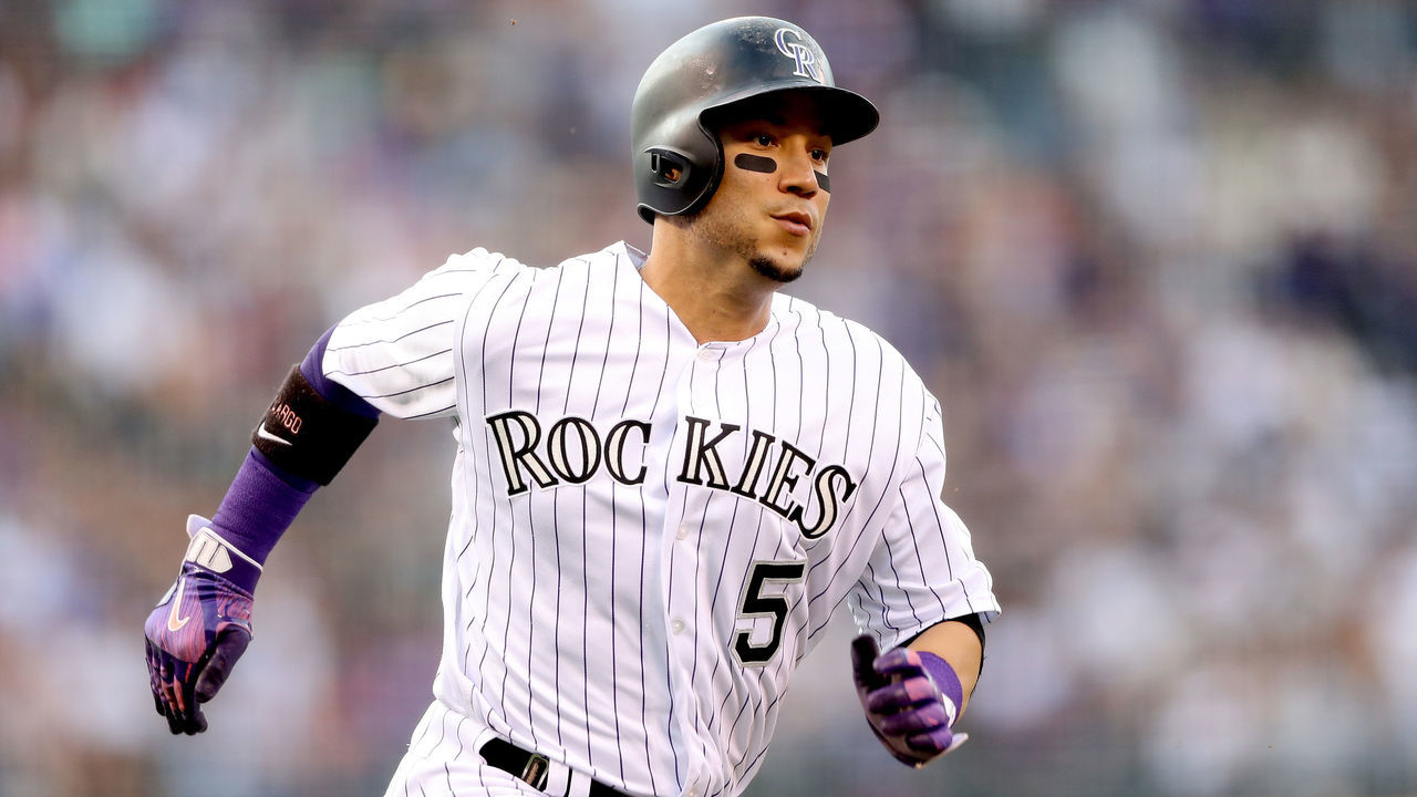 DENVER, CO - AUGUST 05: Carlos Gonzalez #5 of the Colorado Rockies scores on a Pat Valaika single in the first inning against the Philadelphia Phillies at Coors Field on August 5, 2017 in Denver, Colorado.