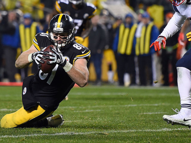 PITTSBURGH, PA - DECEMBER 17: Jesse James #81 of the Pittsburgh Steelers dives for the end zone for an apparent touchdown in the fourth quarter during the game against the New England Patriots at Heinz Field on December 17, 2017 in Pittsburgh, Pennsylvania. After official review, it was ruled an incomplete pass