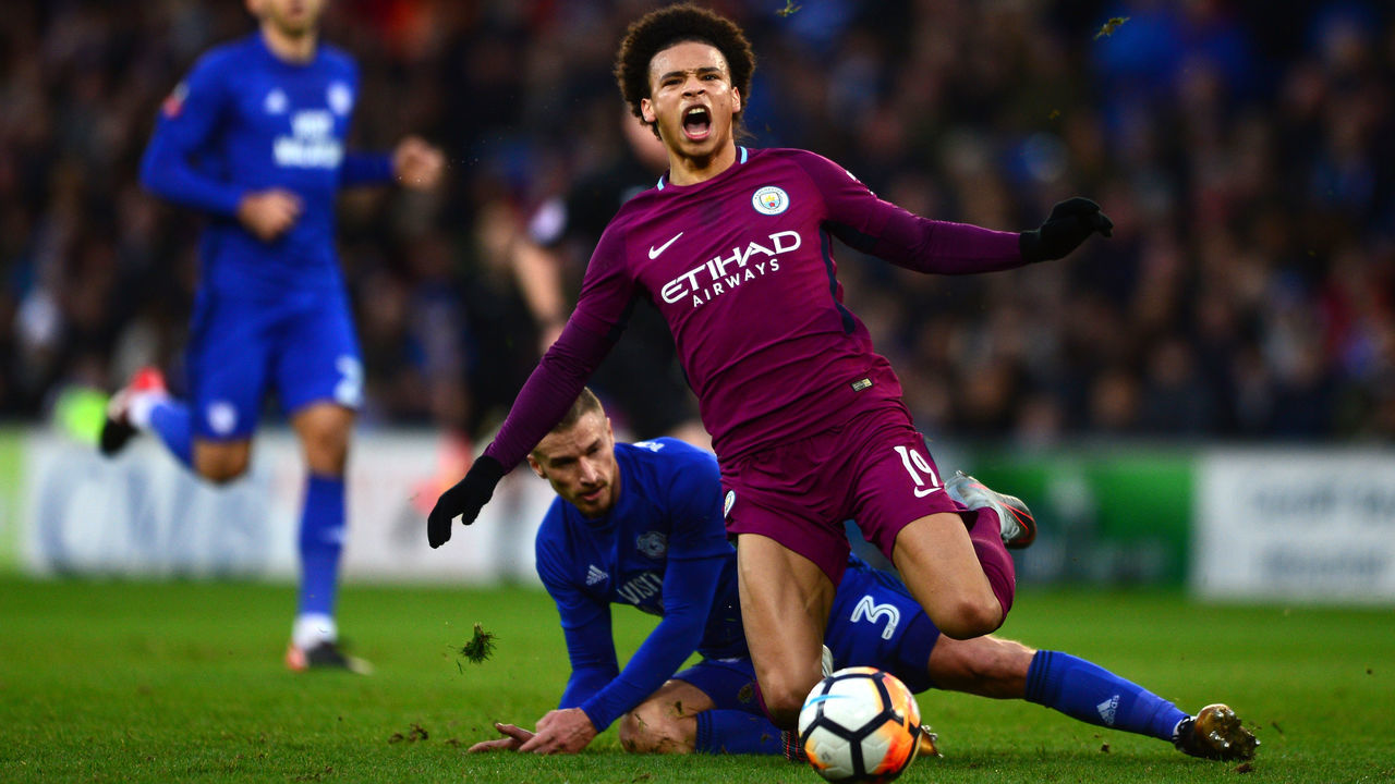 CARDIFF, WALES - JANUARY 28: Leroy Sane of Manchester City is tackled by Joe Bennett of Cardiff City during The Emirates FA Cup Fourth Round between Cardiff City and Manchester City on January 28, 2018 in Cardiff, United Kingdom.