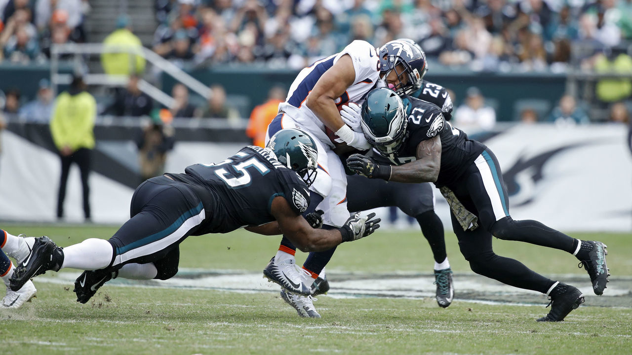 PHILADELPHIA, PA - NOVEMBER 05: Malcolm Jenkins #27 and Brandon Graham #55 of the Philadelphia Eagles make a tackle against the Denver Broncos during a game at Lincoln Financial Field on November 5, 2017 in Philadelphia, Pennsylvania. The Eagles defeated the Broncos 51-23.