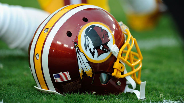 LANDOVER, MD - AUGUST 18: A Washington Redskins helmet sits on the grass during a preseason football game between the Redskins and Cleveland Browns at FedExField on August 18, 2014 in Landover, Maryland.