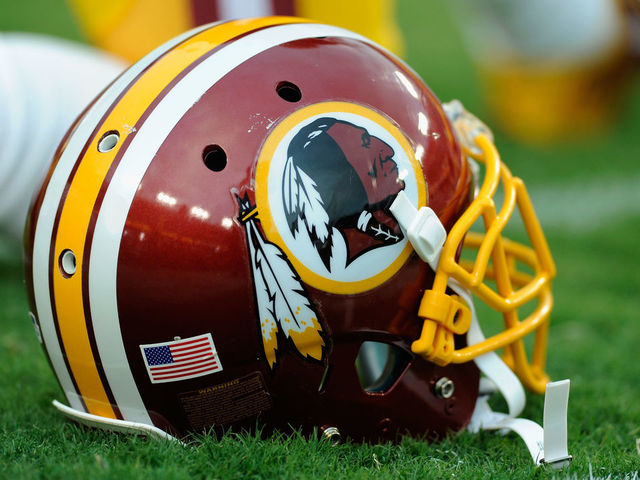 LANDOVER, MD - AUGUST 18: A Washington Redskins helmet sits on the grass during a preseason football game between the Redskins and Cleveland Browns at FedExField on August 18, 2014 in Landover, Maryland.