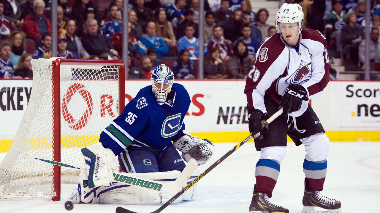VANCOUVER, BC - APRIL 10: Nathan MacKinnon #29 of the Colorado Avalanche tries to redirect a shot onto goalie Jacob Markstrom #35 of the Vancouver Canucks during the first period in NHL action on April 10, 2014 at Rogers Arena in Vancouver, British Columbia, Canada.